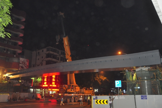 长38米、沉达87吨的钢箱梁，被200吨吊车稳稳地吊装在两个桥梁墩柱之上